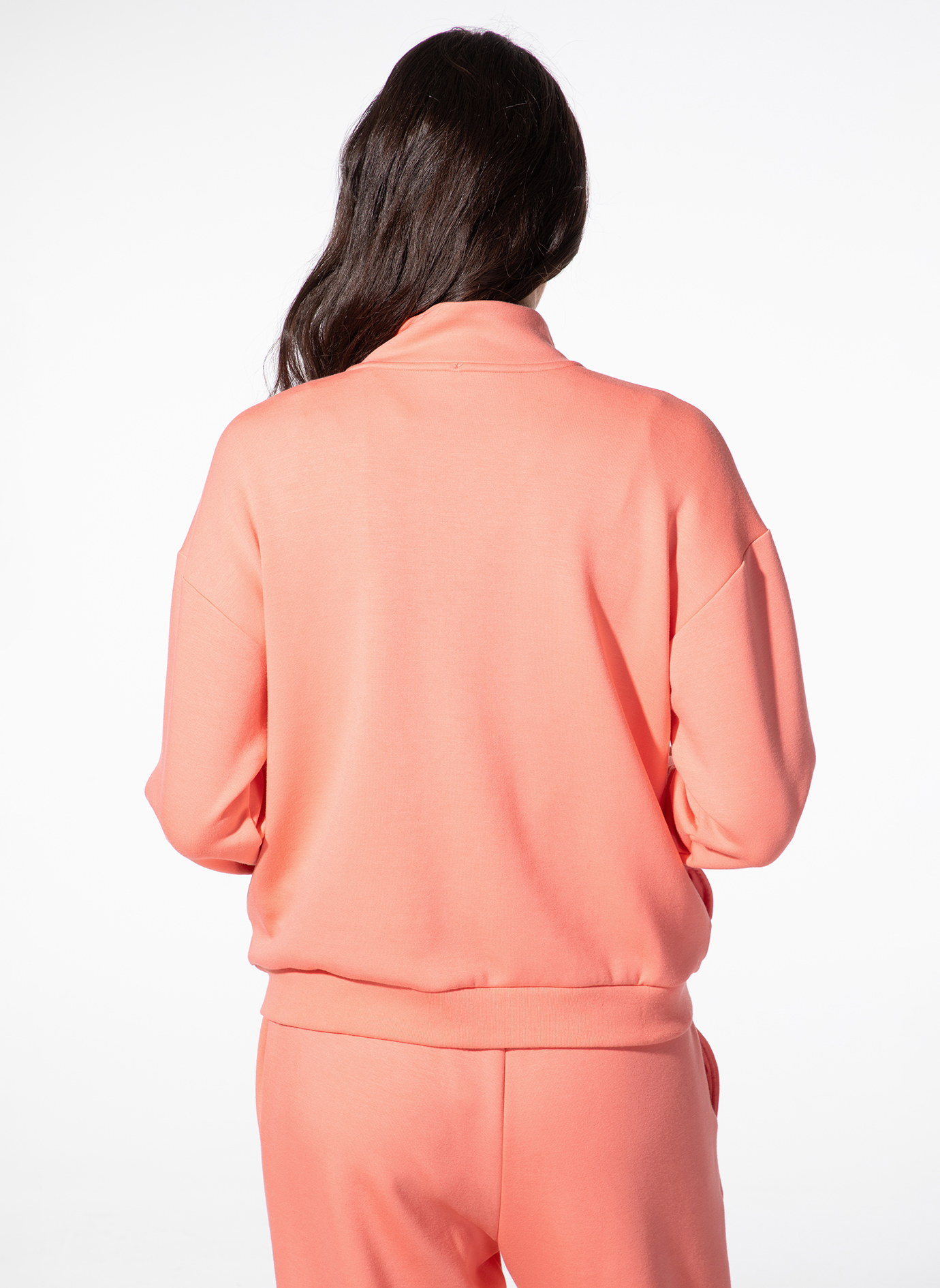 pale, peach, sweatshirt, joggers, back view